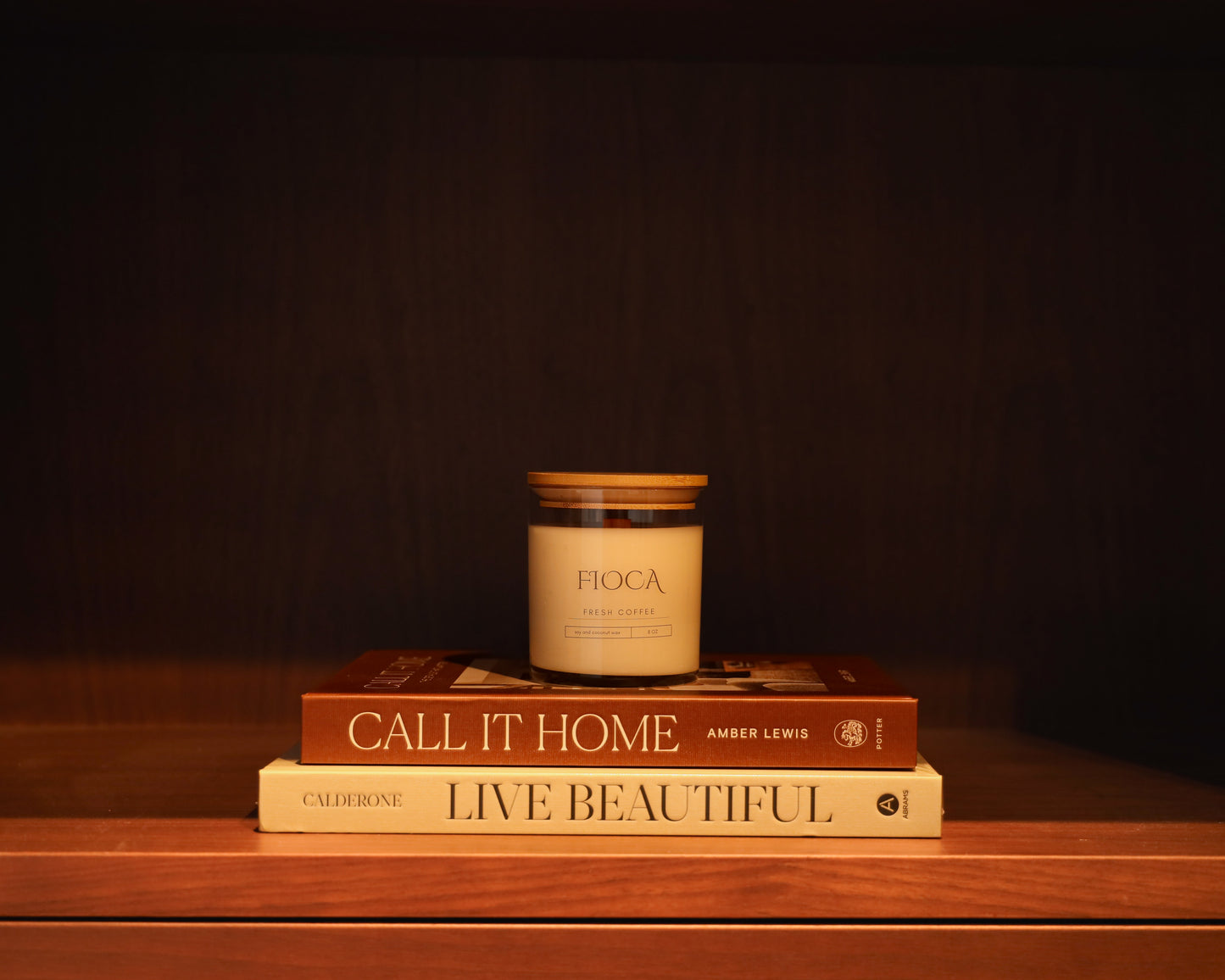 Fioca Fresh Coffee candle styled on top of home decor books “Call It Home” and “Live Beautiful,” symbolizing cozy living and thoughtful design