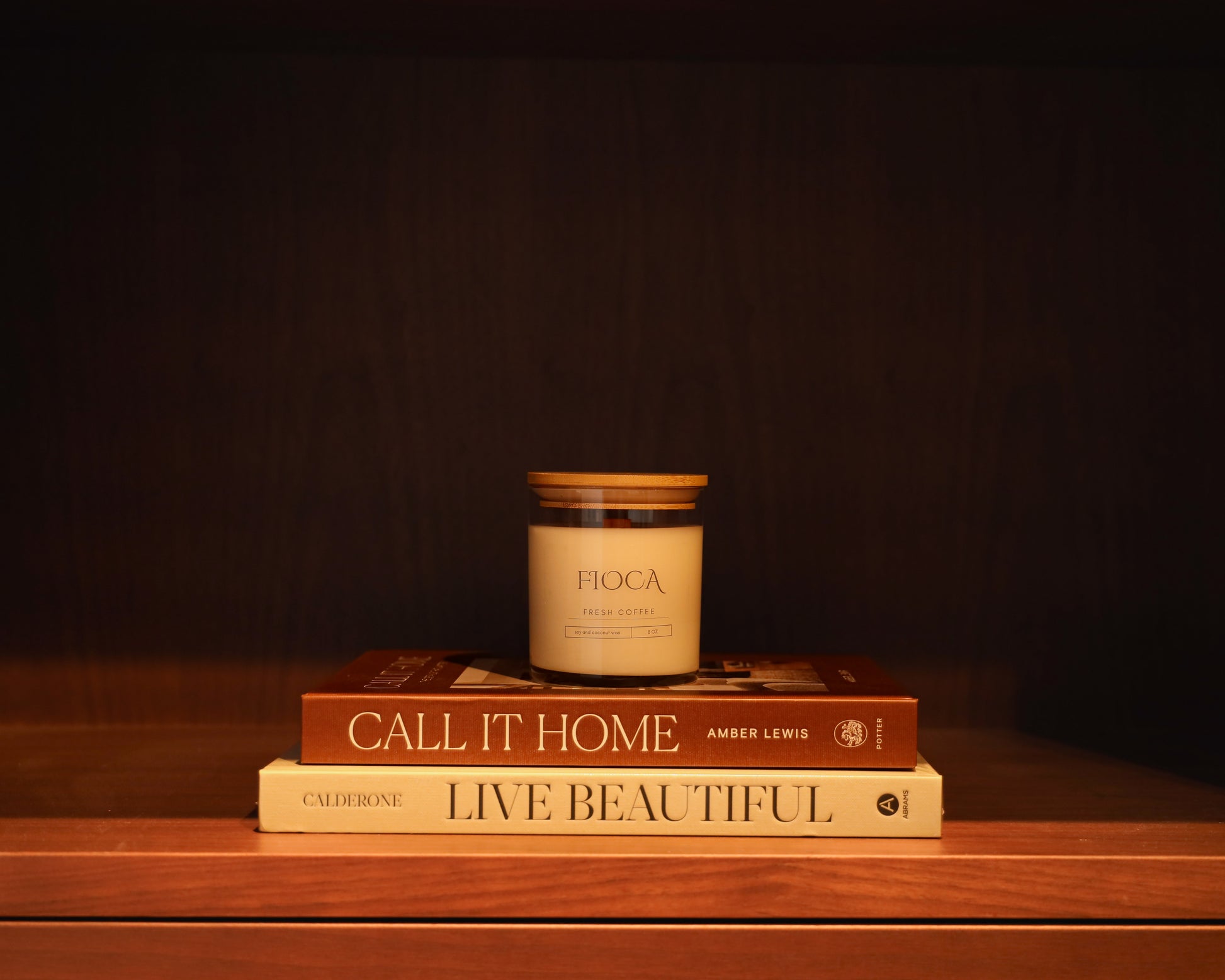Fioca Fresh Coffee candle styled on top of home decor books “Call It Home” and “Live Beautiful,” symbolizing cozy living and thoughtful design