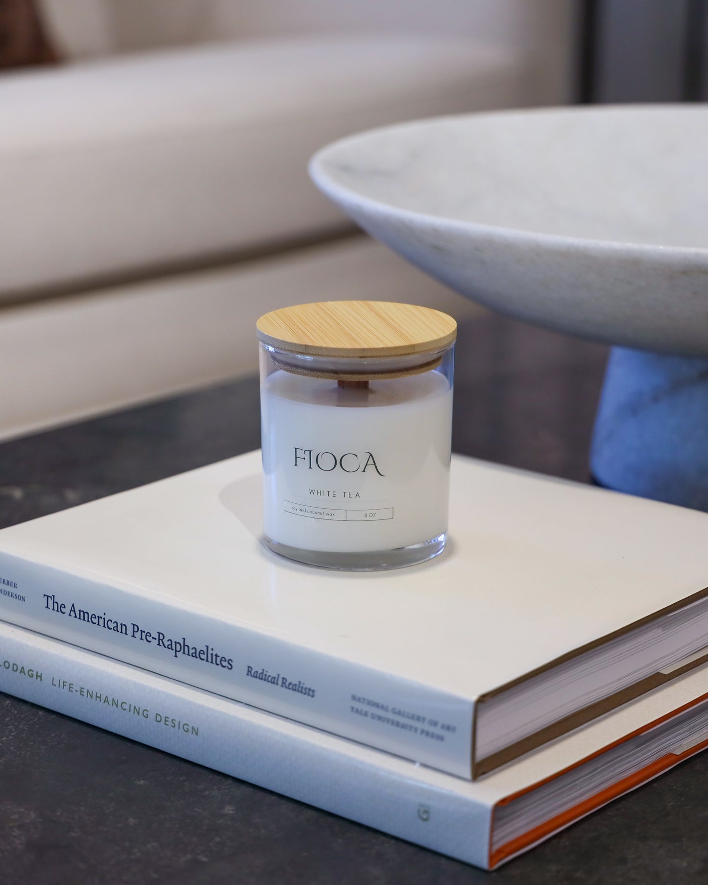 Fioca White Tea on top of books in an elegant room, capturing refined luxury and aesthetically pleasing environment 