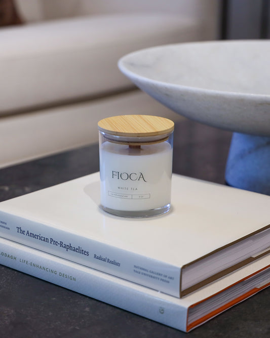 Fioca White Tea on top of books in an elegant room, capturing refined luxury and aesthetically pleasing environment 