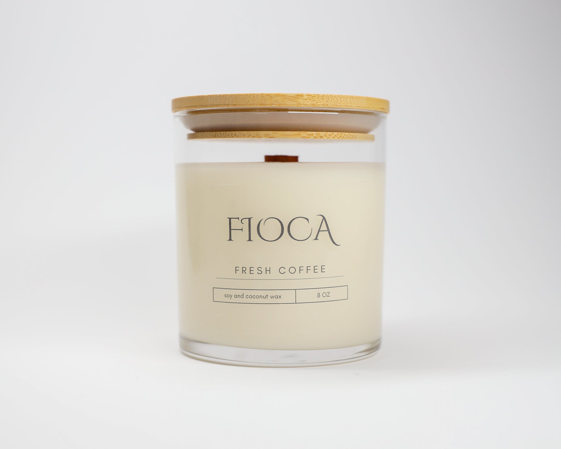Close-up product image of Fioca Fresh Coffee candle in front of a white backdrop, showcasing sustainable design and handcrafted detail