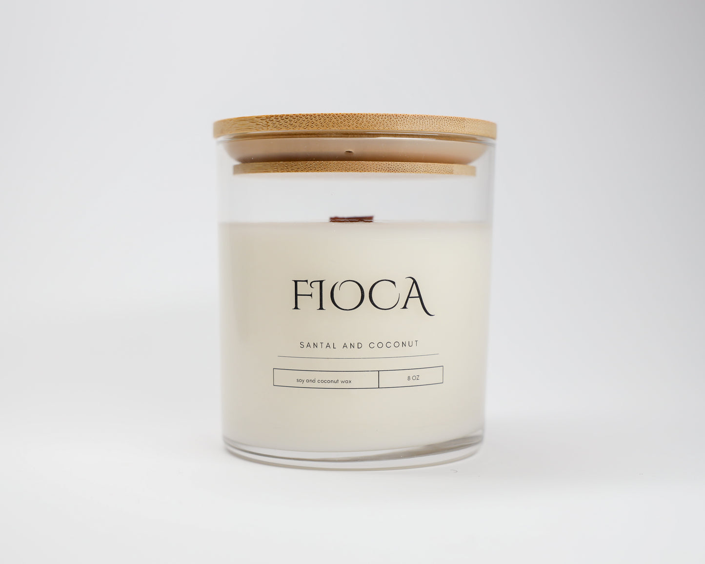 Fioca Santal and Coconut candle photographed in a studio setting with a white background, illustrating refined packaging and eco-conscious craftsmanship