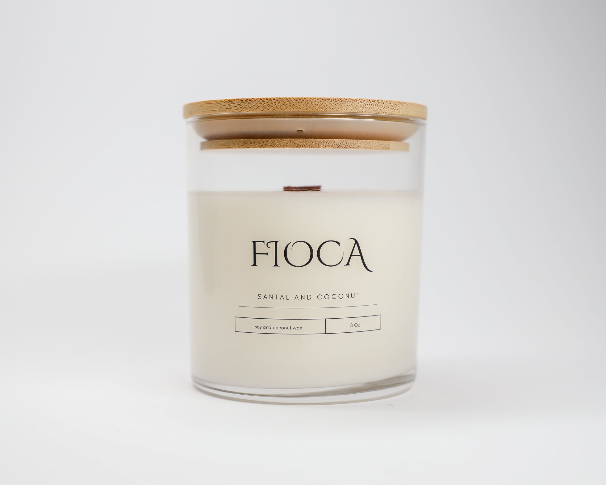 Fioca Santal and Coconut candle photographed in a studio setting with a white background, illustrating refined packaging and eco-conscious craftsmanship