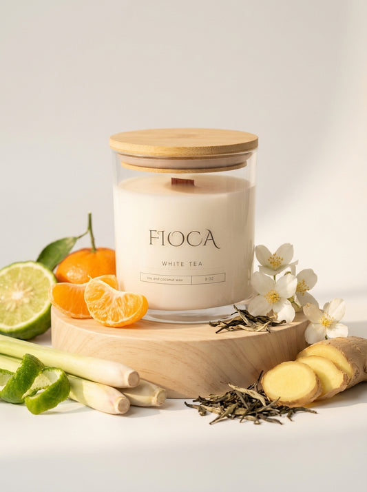 Fioca white tea candle with fruits and flowers on a light background